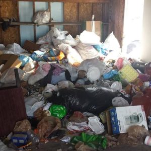 A residential garage filled with junk.